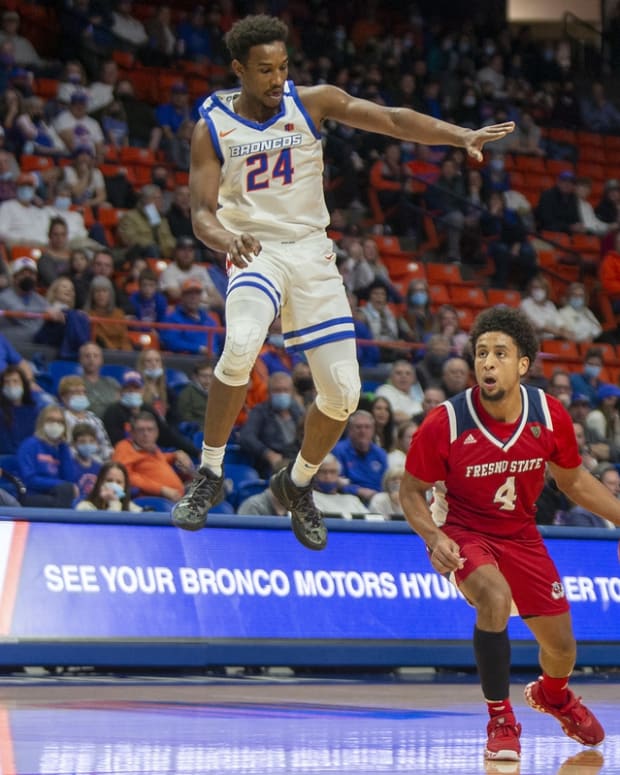 Dec 28, 2021; Boise, Idaho, USA; Fresno State Bulldogs guard Junior Ballard (4) dribbles the ball against Boise State Broncos forward Abu Kigab (24) during the first half at ExtraMile Arena. Mandatory Credit: Brian Losness-USA TODAY Sports