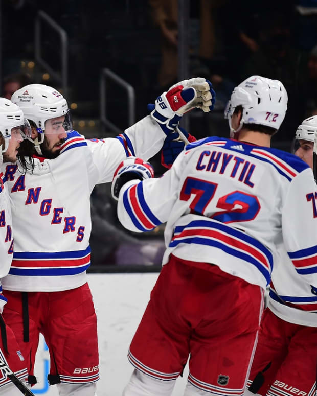 Jan 10, 2022; Los Angeles, California, USA; New York Rangers center Mika Zibanejad (93) celebrates with defenseman Ryan Lindgren (55) center Filip Chytil (72) and defenseman Adam Fox (23) his goal scored against the Los Angeles Kings during the third period at Crypto.com Arena. Mandatory Credit: Gary A. Vasquez-USA TODAY Sports