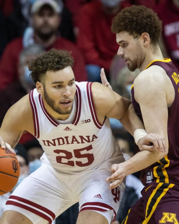 Jan 9, 2022; Bloomington, Indiana, USA; Indiana Hoosiers forward Race Thompson (25) dribbles the ball while Minnesota Golden Gophers forward Jamison Battle (10) defends in the second half at Simon Skjodt Assembly Hall. Mandatory Credit: Trevor Ruszkowski-USA TODAY Sports