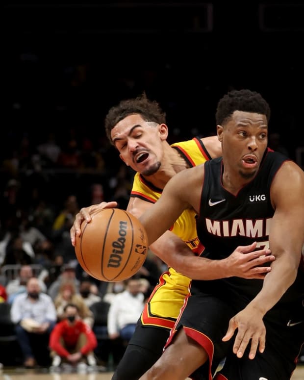 Jan 12, 2022; Atlanta, Georgia, USA; Miami Heat guard Kyle Lowry (7) gets by the defense of Atlanta Hawks guard Trae Young (11) on a pick by Miami Heat forward P.J. Tucker (17) during the second quarter at State Farm Arena. Mandatory Credit: Jason Getz-USA TODAY Sports