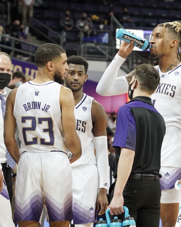 Nate Roberts rehydrates during a Husky timeout.