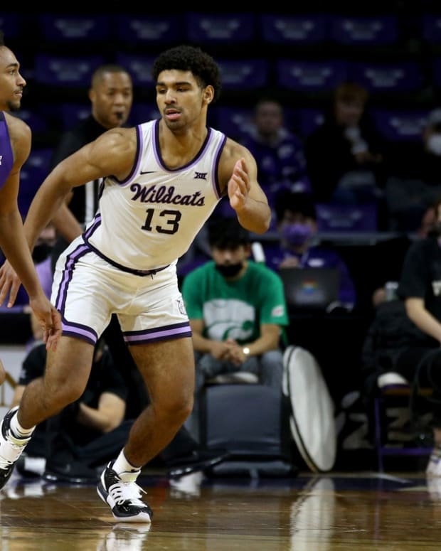 Jan 12, 2022; Manhattan, Kansas, USA; TCU Horned Frogs forward Chuck O Bannon Jr. (5) dribbles against Kansas State Wildcats guard Mark Smith (13) during the first half at Bramlage Coliseum. Mandatory Credit: Scott Sewell-USA TODAY Sports