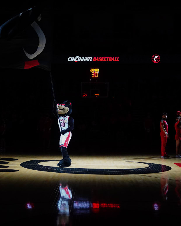 The Cincinnati Bearcats mascot waves the University of Cincinnati flag as the team is introduced before the first half of an NCAA men's college basketball game against the Tulsa Golden Hurricane, Thursday, Jan. 20, 2022, at Fifth Third Arena in Cincinnati. Tulsa Golden Hurricane At Cincinnati Bearcats Basketball Jan 20