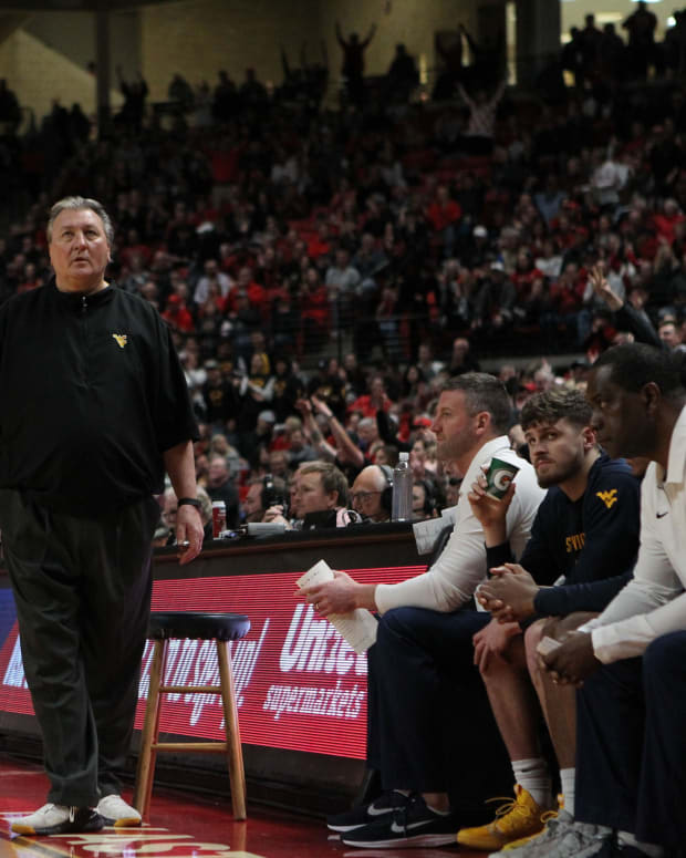 Jan 29, 2020; Lubbock, Texas, USA; West Virginia Mountaineers head coach Bob Huggins checks the scoreboard in the first half during the game against the Texas Tech Red Raiders at United Supermarkets Arena.