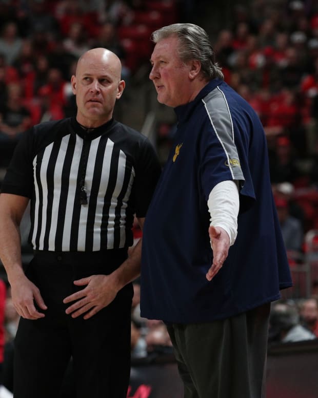 Jan 22, 2022; Lubbock, Texas, USA; West Virginia Mountaineers head coach Bob Huggins discusses a call in the first half with Big 12 official Kipp Kissinger during the game against the Texas Tech Red Raiders at United Supermarkets Arena.