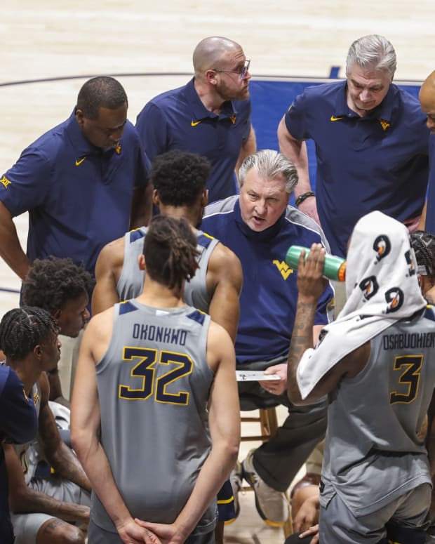 Jan 11, 2022; Morgantown, West Virginia, USA; West Virginia Mountaineers head coach Bob Huggins talks to his team during a timeout during the second half against the Oklahoma State Cowboys at WVU Coliseum.