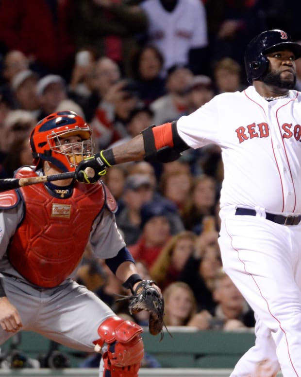 Oct 23, 2013; Boston, MA, USA; Boston Red Sox designated hitter David Ortiz drives in a run with a sacrifice fly in the second inning against the St. Louis Cardinals during game one of the MLB baseball World Series at Fenway Park. Mandatory Credit: Robert Deutsch-USA TODAY Sports