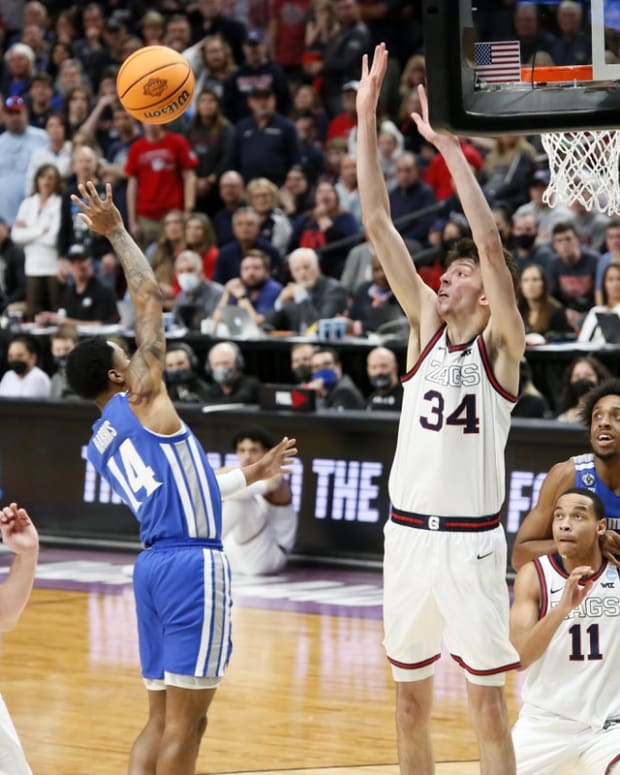 Mar 19, 2022; Portland, OR, USA; Memphis Tigers guard Tyler Harris (14) shoots the ball while Gonzaga Bulldogs center Chet Holmgren (34) defends during the second half in the second round of the 2022 NCAA Tournament at Moda Center. Mandatory Credit: Soobum Im-USA TODAY Sports