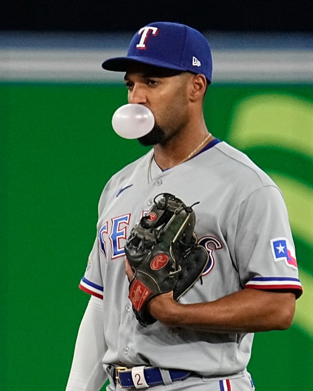 Apr 10, 2022; Toronto, Ontario, CAN; Texas Rangers second baseman Marcus Semien (2) blows a bubble during the ninth inning against the Toronto Blue Jays at Rogers Centre. Mandatory Credit: John E. Sokolowski-USA TODAY Sports