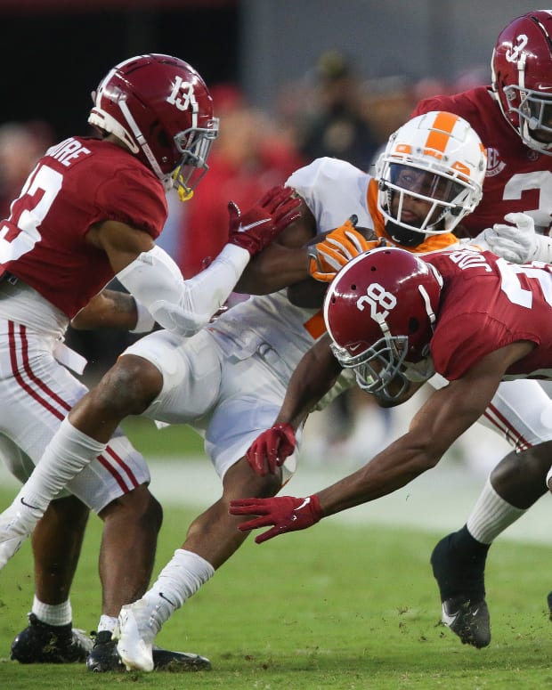 Tennessee Volunteers wide receiver Velus Jones Jr. (1) is stopped by Alabama Crimson Tide defensive back Malachi Moore (13) and defensive back Josh Jobe (28) during the first half at Bryant-Denny Stadium.