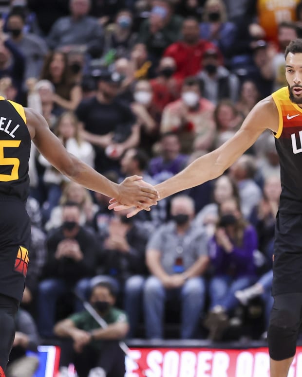 Utah Jazz guard Donovan Mitchell (45) and center Rudy Gobert (27) slap hands after a play in the fourth quarter against the San Antonio Spurs at Vivint Arena.