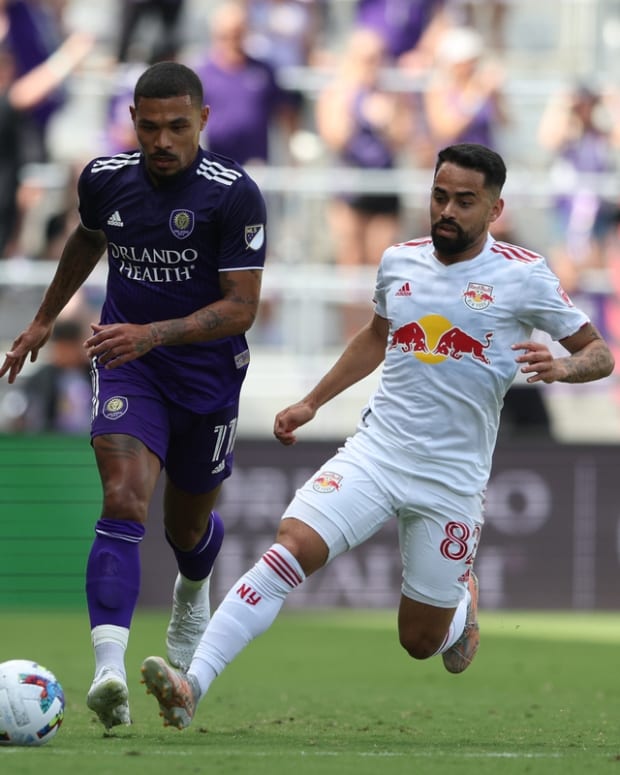Apr 24, 2022; Orlando, Florida, USA; Orlando City midfielder Junior Urso (11) controls the ball defended by New York Red Bulls midfielder Luquinhas (82) in the first half at Exploria Stadium. Mandatory Credit: Nathan Ray Seebeck-USA TODAY Sports