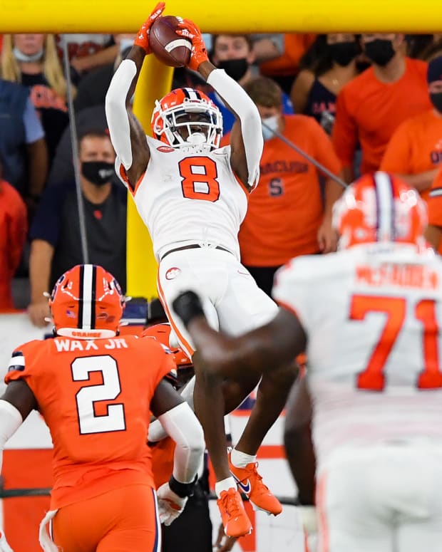 Oct 15, 2021; Syracuse, New York, USA; Clemson Tigers wide receiver Justyn Ross (8) catches the ball in front of Syracuse Orange linebacker Marlowe Wax (2) during the first half at the Carrier Dome. Mandatory Credit: Rich Barnes-USA TODAY Sports