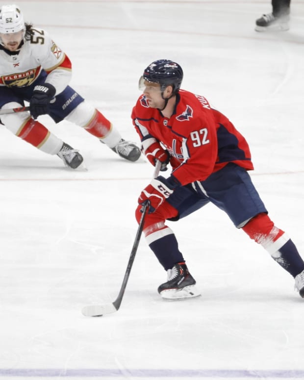 May 9, 2022; Washington, District of Columbia, USA; Washington Capitals center Evgeny Kuznetsov (92) skates with the puck as Florida Panthers defenseman MacKenzie Weegar (52) chases in overtime in game four of the first round of the 2022 Stanley Cup Playoffs at Capital One Arena. Mandatory Credit: Geoff Burke-USA TODAY Sports