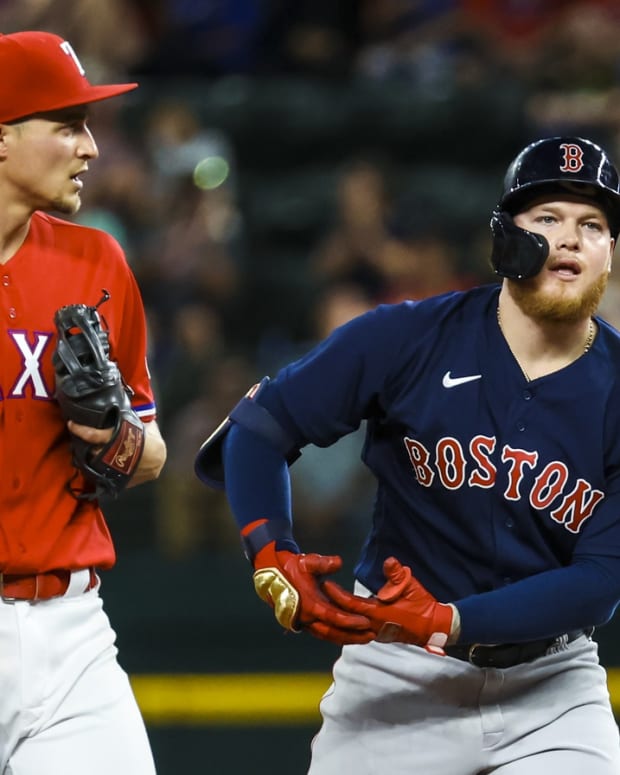 May 13, 2022; Arlington, Texas, USA; Boston Red Sox left fielder Alex Verdugo (99) celebrates in front of Texas Rangers shortstop Corey Seager (5) after hitting an rbi double during the sixth inning at Globe Life Field.
