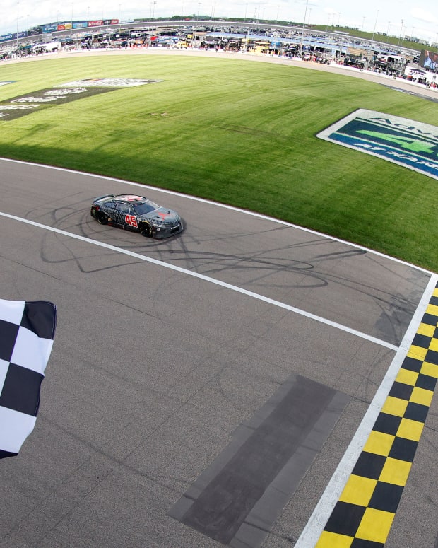Kurt Busch, driver of the #45 Jordan Brand Toyota, takes the checkered flag to win Sunday's NASCAR Cup Series Advent Health 400 at Kansas Speedway. (Photo by Sean Gardner/Getty Images)