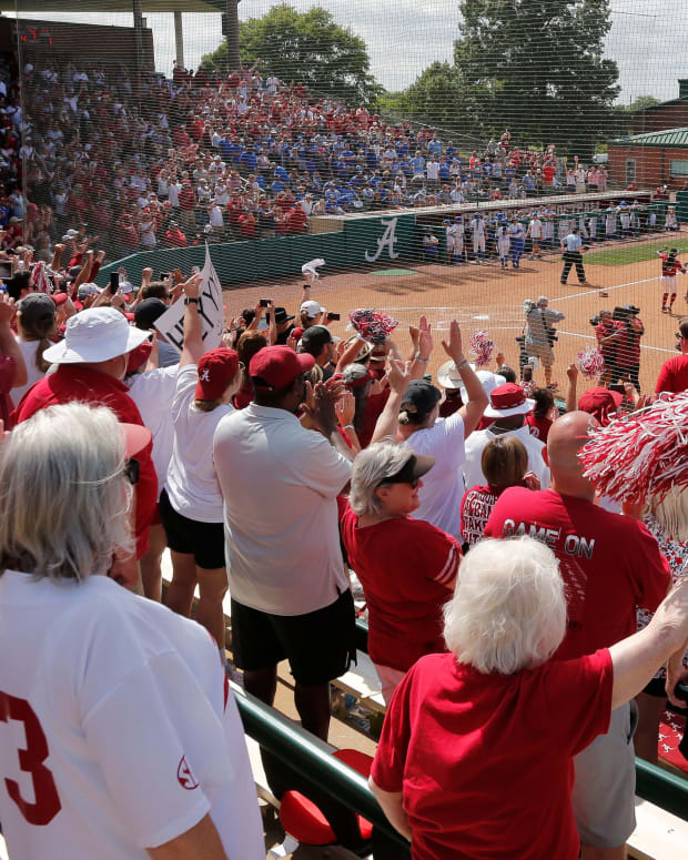 Fans cheer as Crimson Tide players rush the field after Alabama defeated Kentucky 4-1 to advance to the College World Series Saturday Friday, May 29, 2021, in Rhoads Stadium in Tuscaloosa.