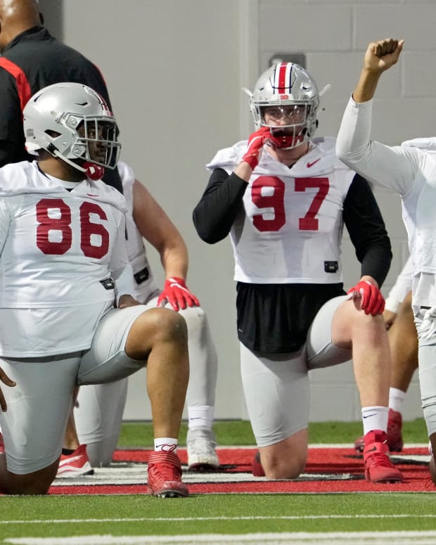 Defensive players Jerron Cage (86), Noah Potter (97) and Javontae Jean-Baptiste (8) stretch during the first practice of spring football for Ohio State University at the Woody Hayes Athletic Center in Columbus on Tuesday, March 8, 2022. Ceb Osufb Spring 0308 Bjp 14