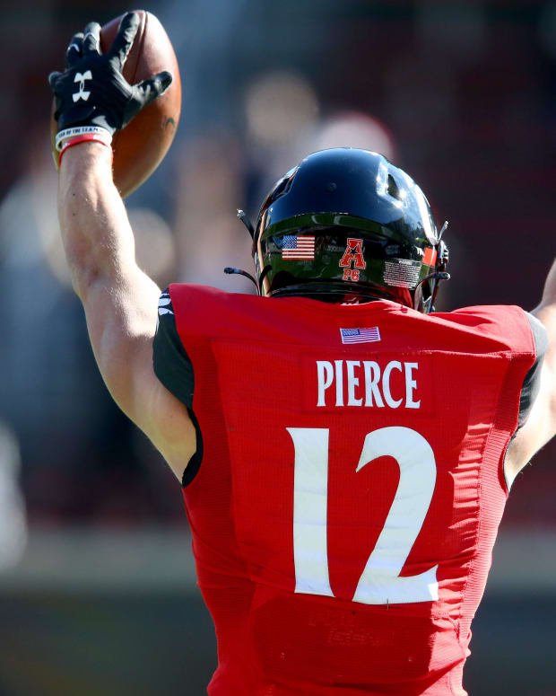Cincinnati Bearcats wide receiver Alec Pierce (12) gestures toward an official after catching a touchdown pass during the first quarter of a college football game against the Memphis Tigers, Saturday, Oct. 31, 2020, at Nippert Stadium in Cincinnati. Ncaa Football Memphis At Cincinnati