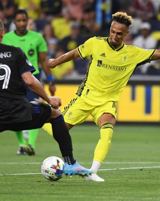 May 18, 2022; Nashville, Tennessee, USA; Nashville SC midfielder Hany Mukhtar (10) shoots the ball before pressure by CF Montreal defender Zorhan Bassong (19) during the second half at GEODIS Park. Mandatory Credit: Christopher Hanewinckel-USA TODAY Sports