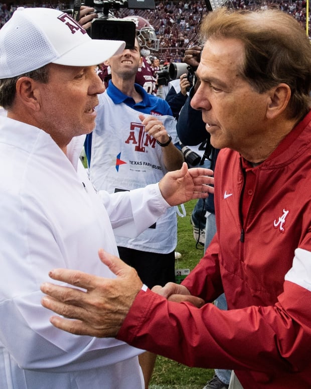 Texas A&M head coach Jimbo Fisher, left, and Alabama head coach Nick Saban meet at midfield after their game in College Station, Texas, in 2019.