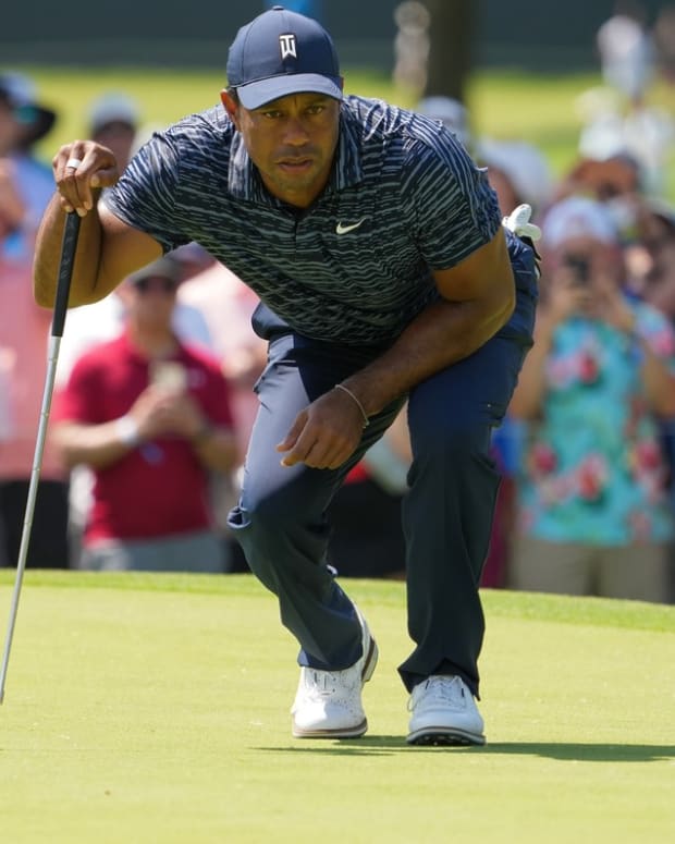May 19, 2022; Tulsa, OK, USA; Tiger Woods lines up a putt on the third green during the first round of the PGA Championship golf tournament at Southern Hills Country Club. Mandatory Credit: Michael Madrid-USA TODAY Sports