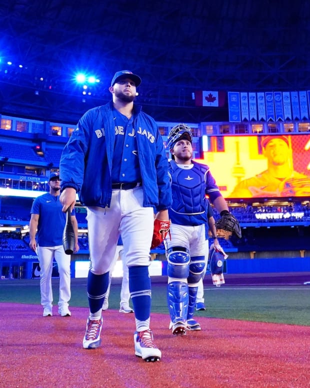 May 3, 2022; Toronto, Ontario, CAN; Toronto Blue Jays pitcher Alek Manoah (center) and catcher Alejandro Kirk (right) head to the dugout before a game against the New York Yankees at Rogers Centre.