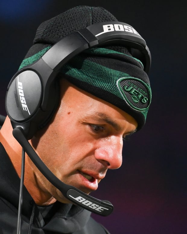 New York Jets head coach Robert Saleh looks down on sideline