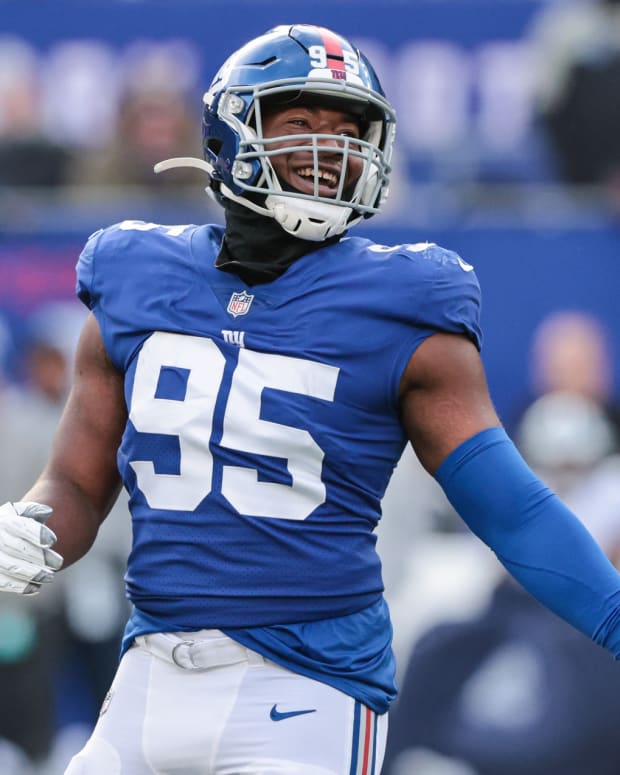 Dec 19, 2021; East Rutherford, New Jersey, USA; New York Giants outside linebacker Quincy Roche (95) reacts after a sack against the Dallas Cowboys during the first half at MetLife Stadium.