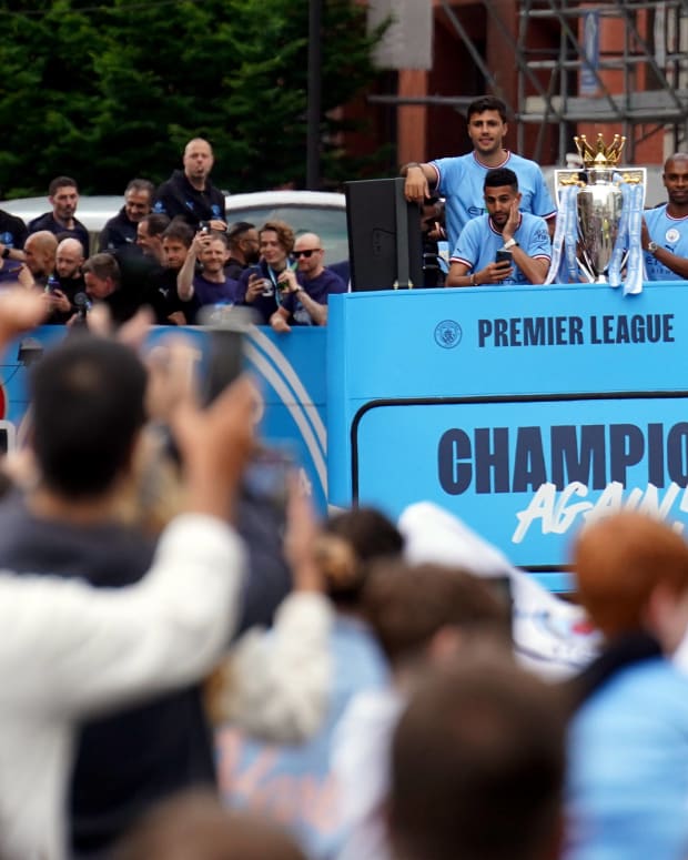 Manchester City's players pictured parading their Premier League trophy from an open-top bus 24 hours after winning it on the final day of the 2021/22 season