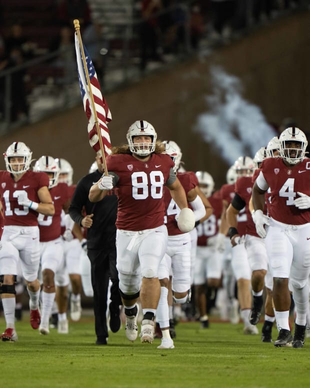 Stanford Cardinal tight end Tucker Fisk (88) runs onto the field with his teammates waving the American flag before the game against the Utah Utes at Stanford Stadium. Mandatory Credit:
