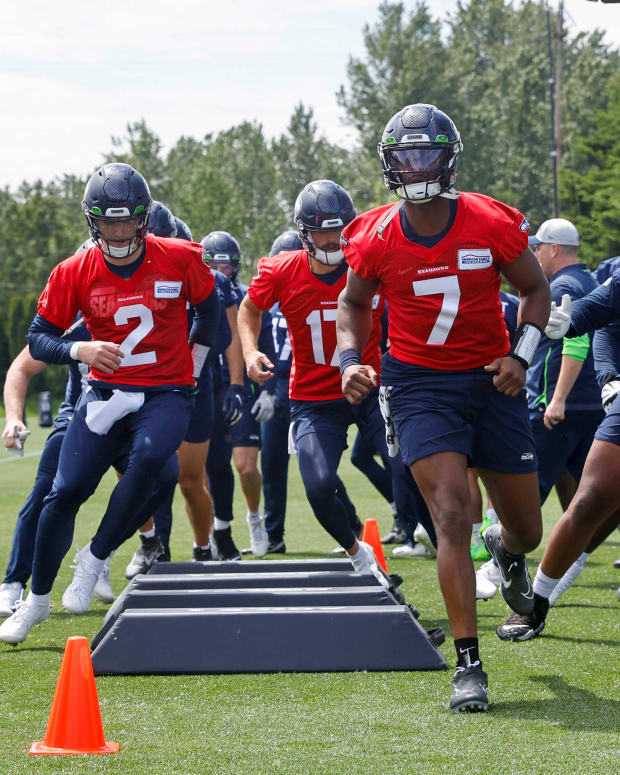 Seattle Seahawks quarterback Geno Smith (7) and quarterback Drew Lock (2) participate in a drill during an OTA workout at the Virginia Mason Athletic Center.