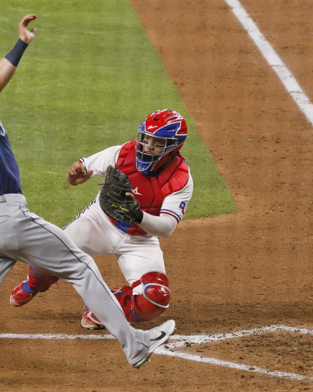 Aug 18, 2021; Arlington, Texas, USA; Texas Rangers catcher Jose Trevino (right) tags out Seattle Mariners right fielder Mitch Haniger (17) as Haniger tries to score during the sixth inning at Globe Life Field.