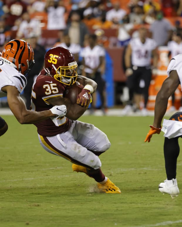 Aug 20, 2021; Landover, Maryland, USA; Washington Football Team running back Jaret Patterson (35) carries the ball as Cincinnati Bengals linebacker Keandre Jones (47) chases in the fourth quarter at FedExField. Mandatory Credit: Geoff Burke-USA TODAY Sports