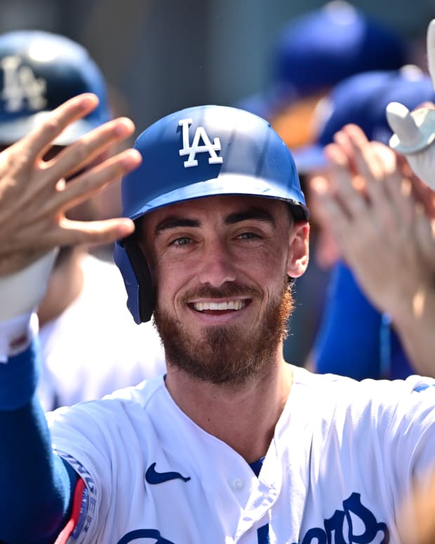Los Angeles Dodgers outfielder Cody Bellinger celebrates with his teammates in the dugout. (2022)