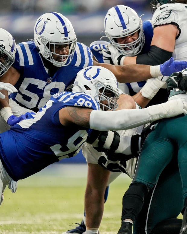Indianapolis Colts defensive tackle DeForest Buckner (99) and Indianapolis Colts defensive end Dayo Odeyingbo (54) work to bring down Philadelphia Eagles running back Miles Sanders (26) on Sunday, Nov. 20, 2022, during a game against the Philadelphia Eagles at Lucas Oil Stadium in Indianapolis.