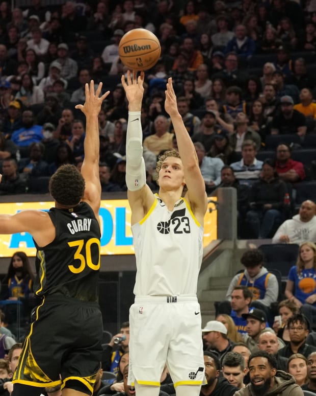 Utah Jazz forward Lauri Markkanen (23) shoots against Golden State Warriors guard Stephen Curry (30) during the third quarter at Chase Center.