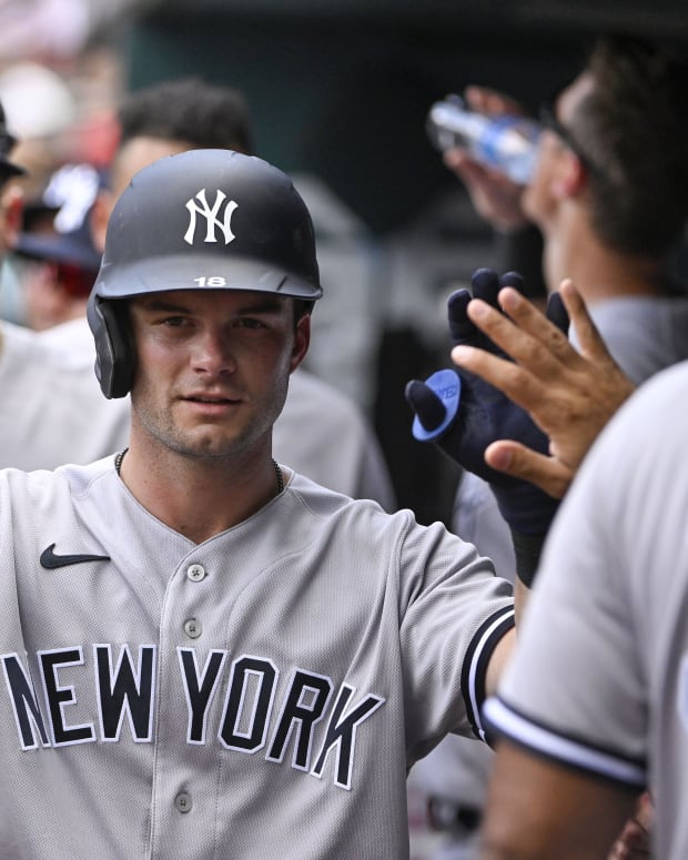 New York Yankees OF Andrew Benintendi high fives in dugout