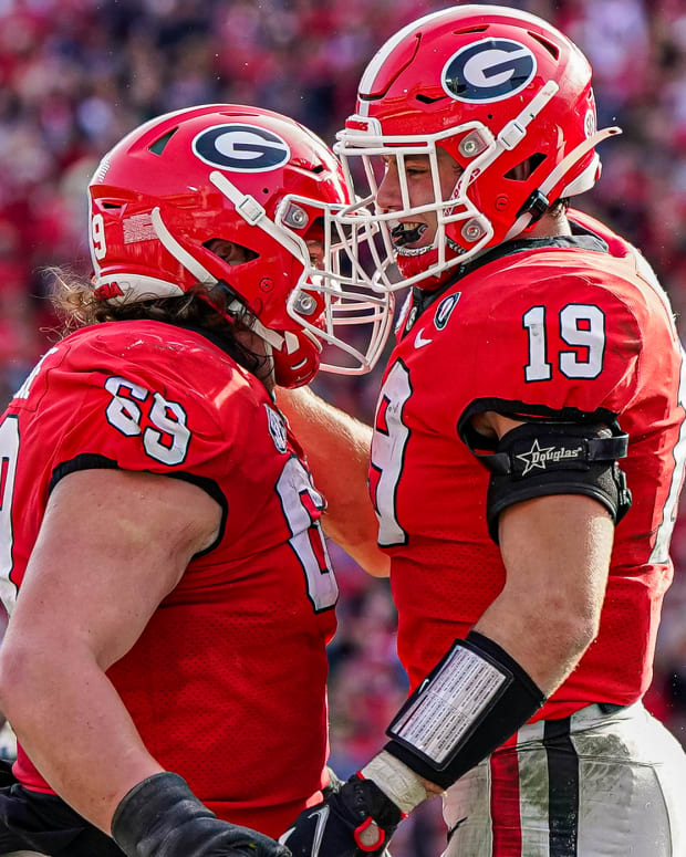 Georgia Bulldogs tight end Brock Bowers (19) reacts with offensive lineman Tate Ratledge (69) after catching a touchdown pass
