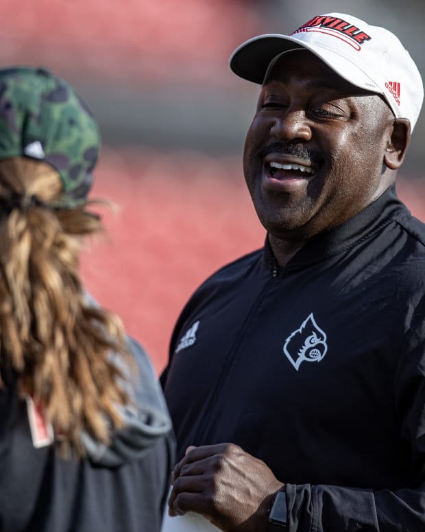 Co-defensive coordinator, Wesley McGriff, right, has a laugh during U of L's first spring football practice of 2022 on Monday afternoon. Feb. 28, 2022 As 1304 Cardinal Football