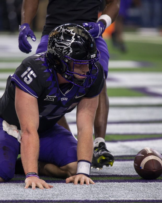 Dec 3, 2022; Arlington, TX, USA; TCU Horned Frogs quarterback Max Duggan (15) kneels on the field after scoring a touchdown against the Kansas State Wildcats during the second half at AT&T Stadium.