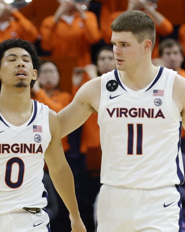 Virginia Cavaliers guard Kihei Clark (0) reacts with Cavaliers guard Isaac McKneely (11) after their game against the James Madison Dukes at John Paul Jones Arena.