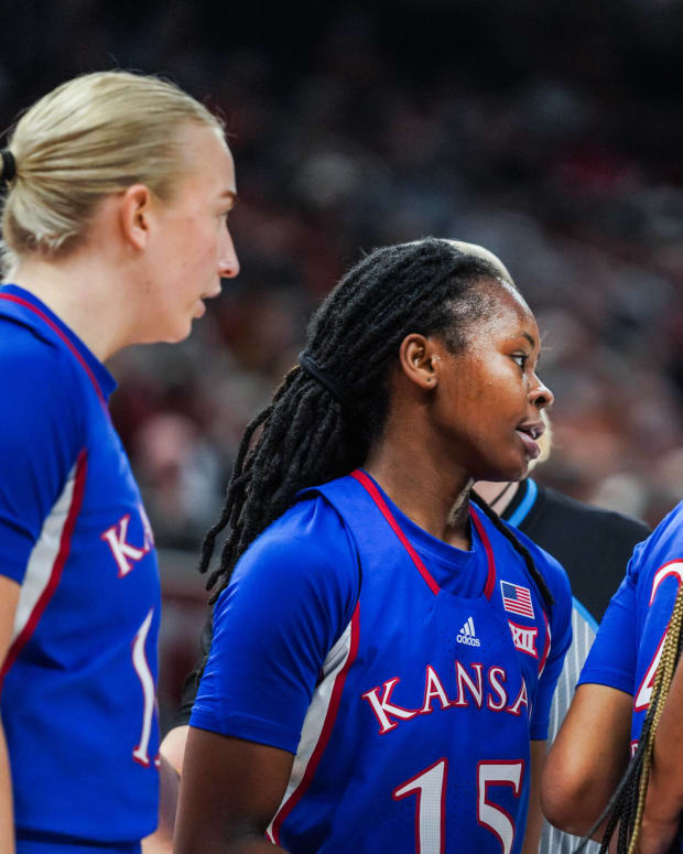 The Kansas Jayhawks huddle during a timeout against the Texas Longhorns in Austin, TX.
