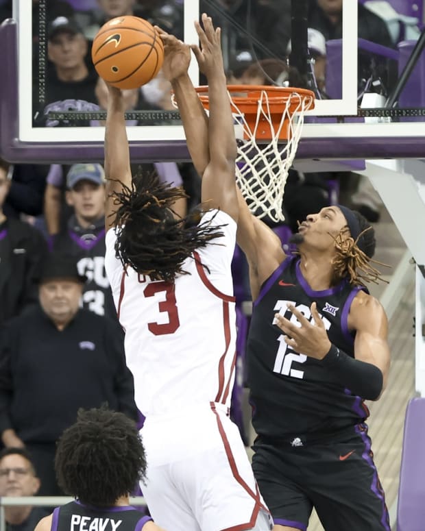 Jan 24, 2023; Fort Worth, Texas, USA; TCU Horned Frogs forward Xavier Cork (12) blocks the shot of Oklahoma Sooners guard Otega Oweh (3) during the first half at Ed and Rae Schollmaier Arena.