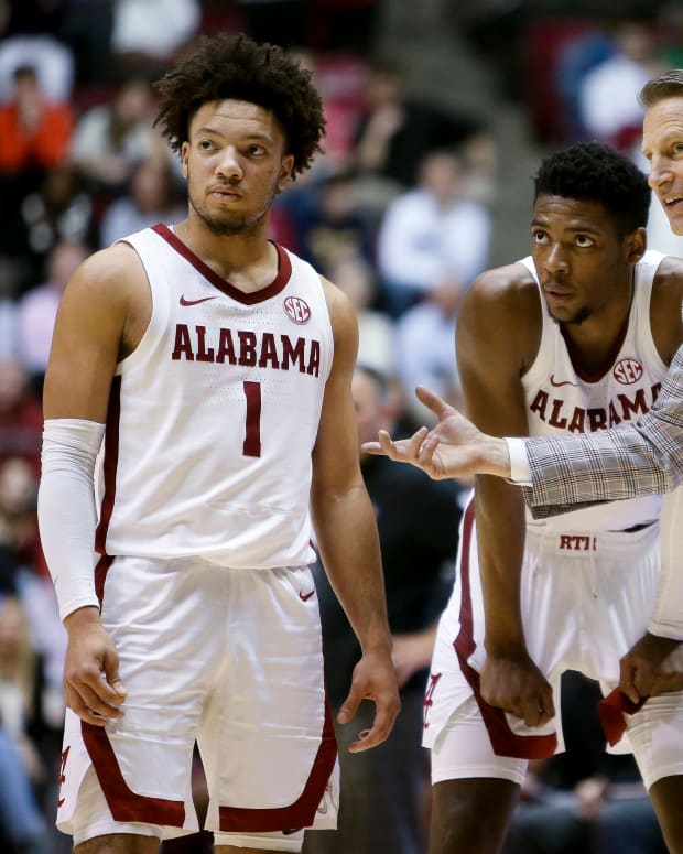 Alabama head coach Nate Oats talks with Alabama guard Mark Sears (1) and Alabama forward Brandon Miller (24) during a free throw at Coleman Coliseum. Alabama came from behind to defeat Mississippi State 66-63.