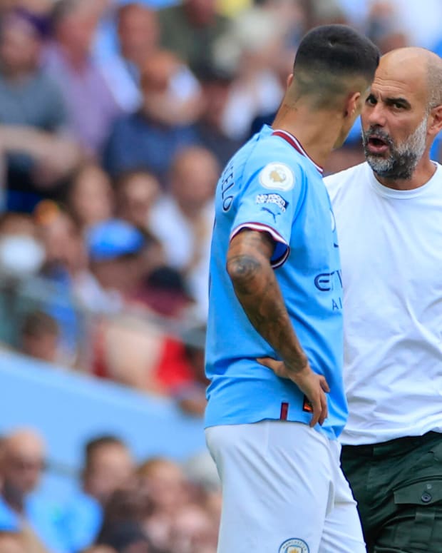Pep Guardiola (right) pictured speaking to Joao Cancelo during Manchester City's game against Bournemouth in August 2022