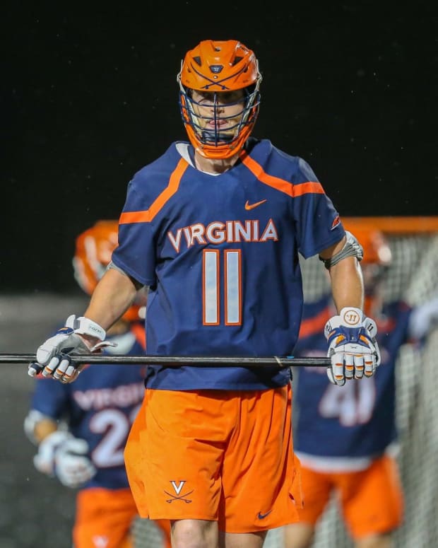 Cade Saustad playing defense during the Virginia men's lacrosse game against Brown in the first round of the 2022 NCAA Division I Men's Lacrosse Tournament in Providence.