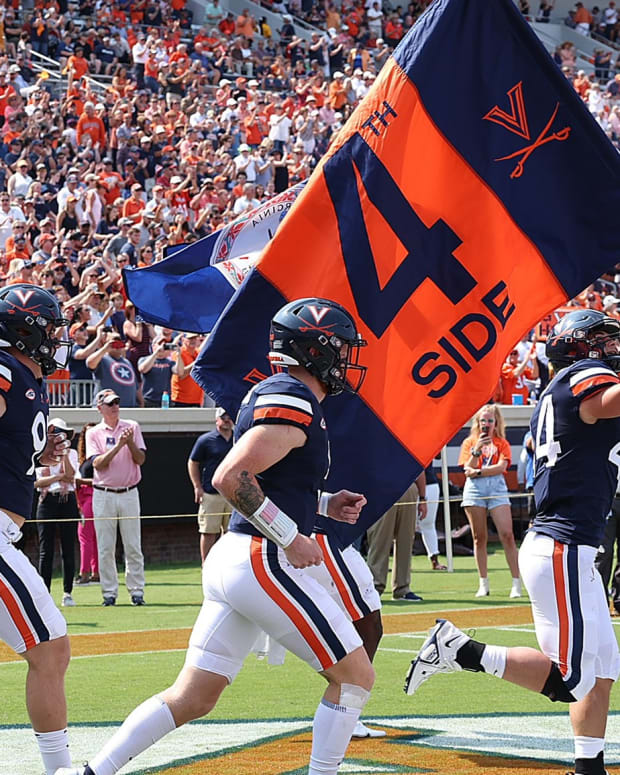 The Virginia Cavaliers football team takes the field before the game against Louisville at Scott Stadium.