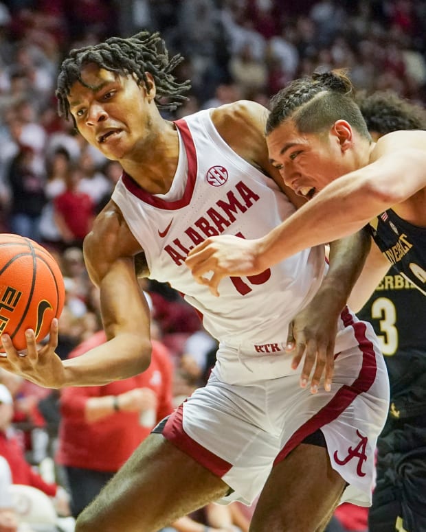 Alabama Crimson Tide forward Noah Clowney (15) goes for the ball against Vanderbilt Commodores forward Quentin Millora-Brown (42) during the second half at Coleman Coliseum.
