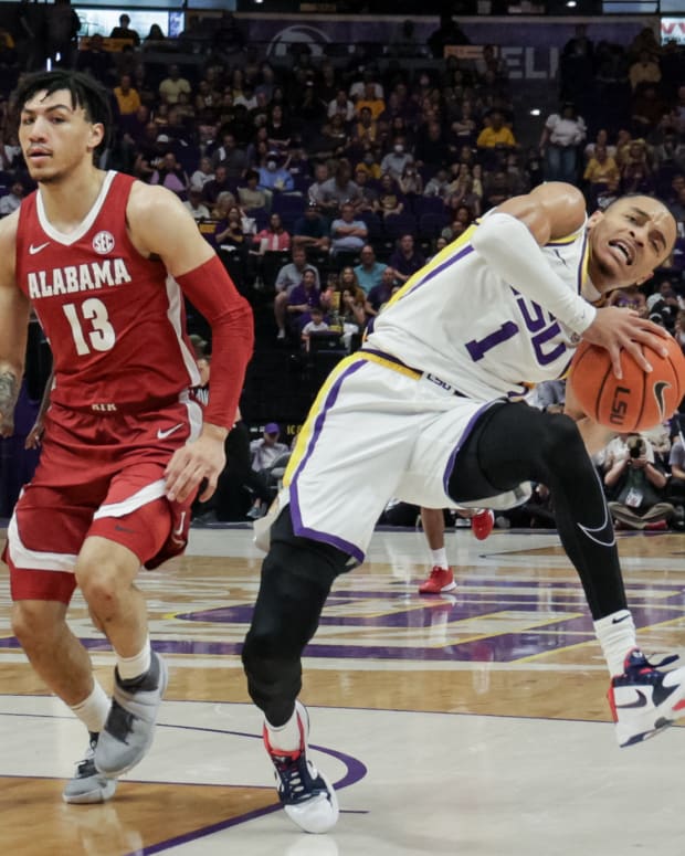 LSU Tigers guard Xavier Pinson (1) is fouled by Alabama Crimson Tide guard Jahvon Quinerly (13) during the first half at the Pete Maravich Assembly Center.